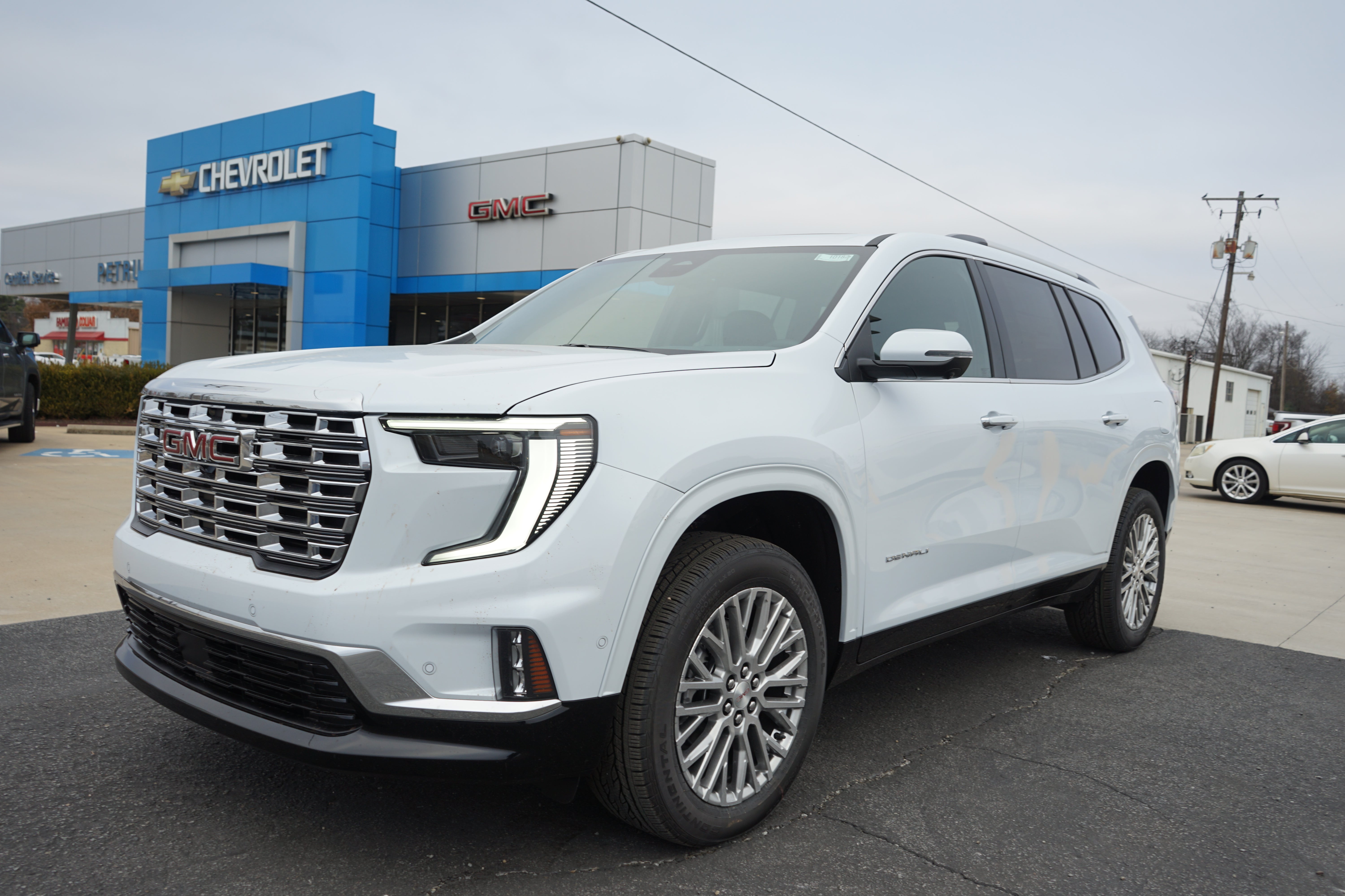 2026 GMC Acadia Denali in Glacier White Tricoat — front three-quarter view