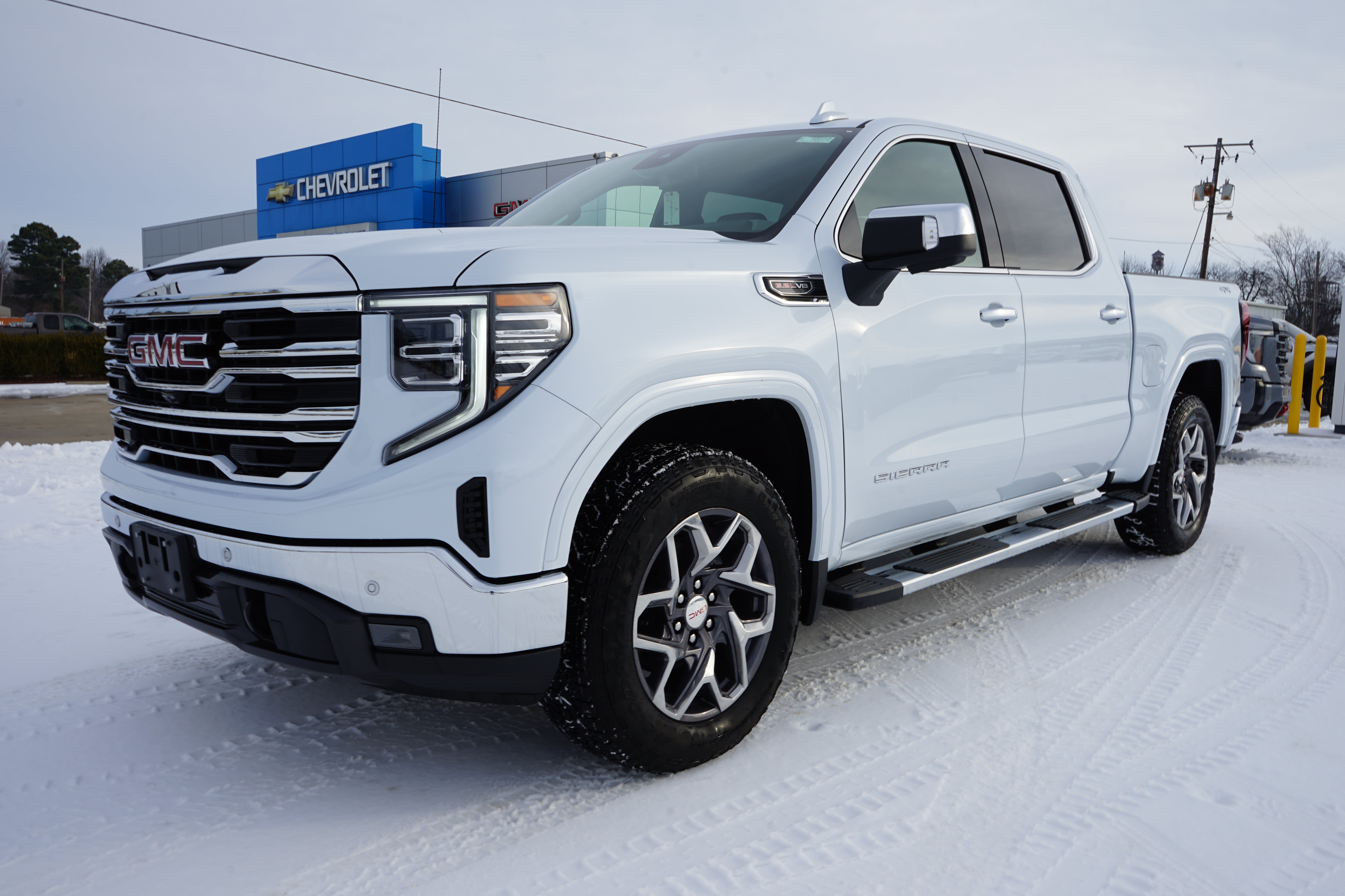 2026 GMC Sierra 1500 SLT in Glacier White Tricoat — front three-quarter view