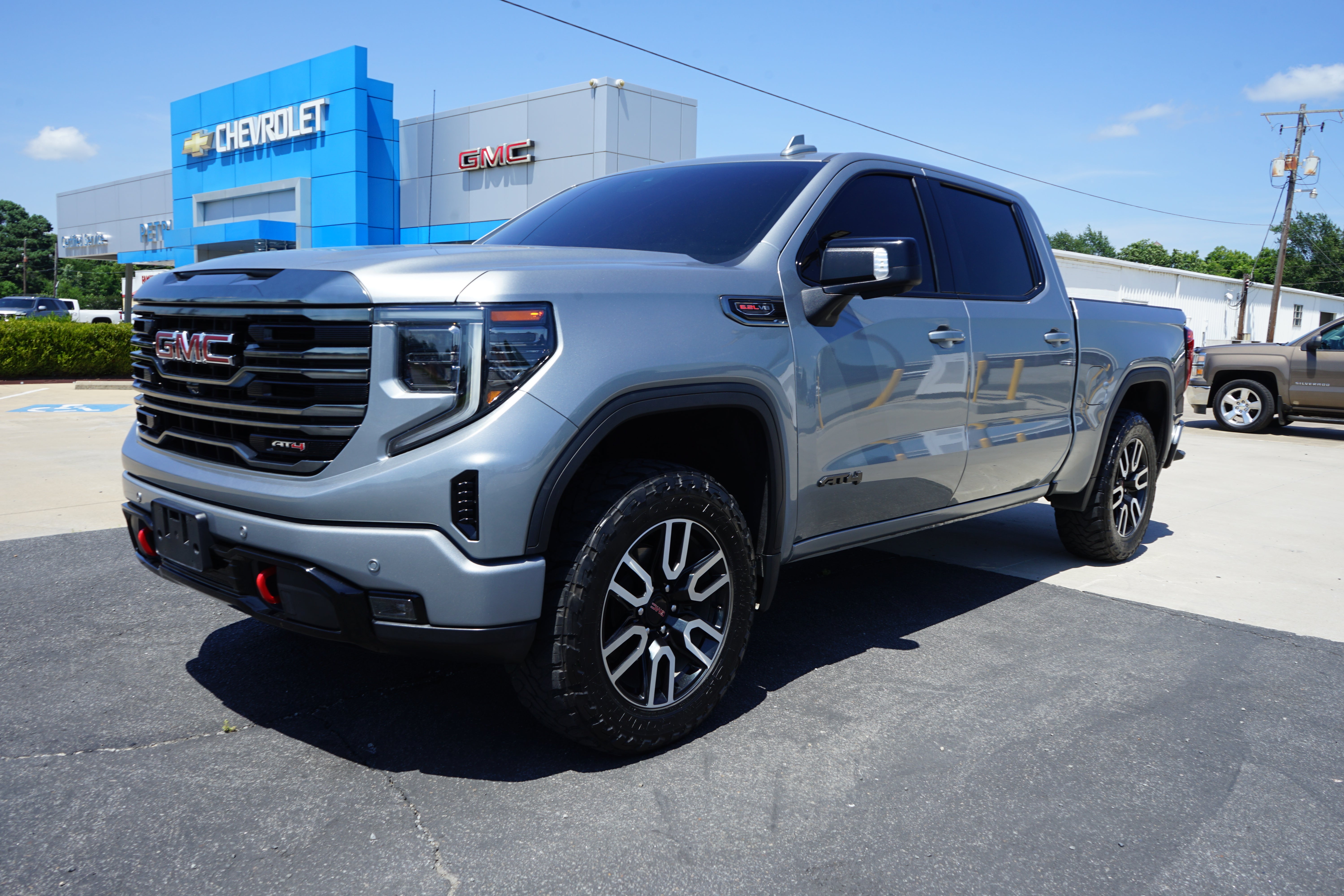 2023 GMC Sierra 1500 AT4 in Sterling Metallic — front three-quarter view