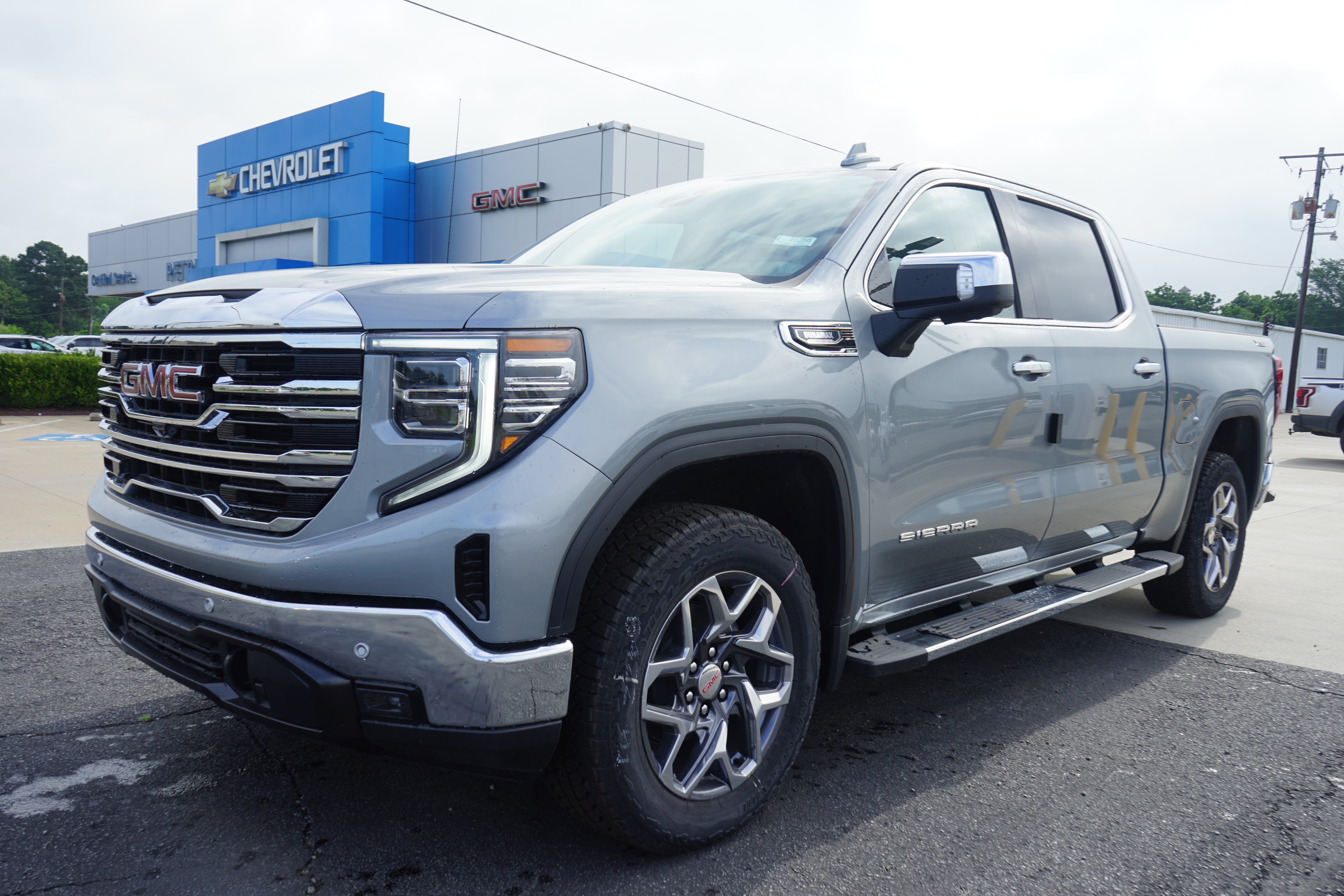 2026 GMC Sierra 1500 SLT in Sterling Metallic — front three-quarter view