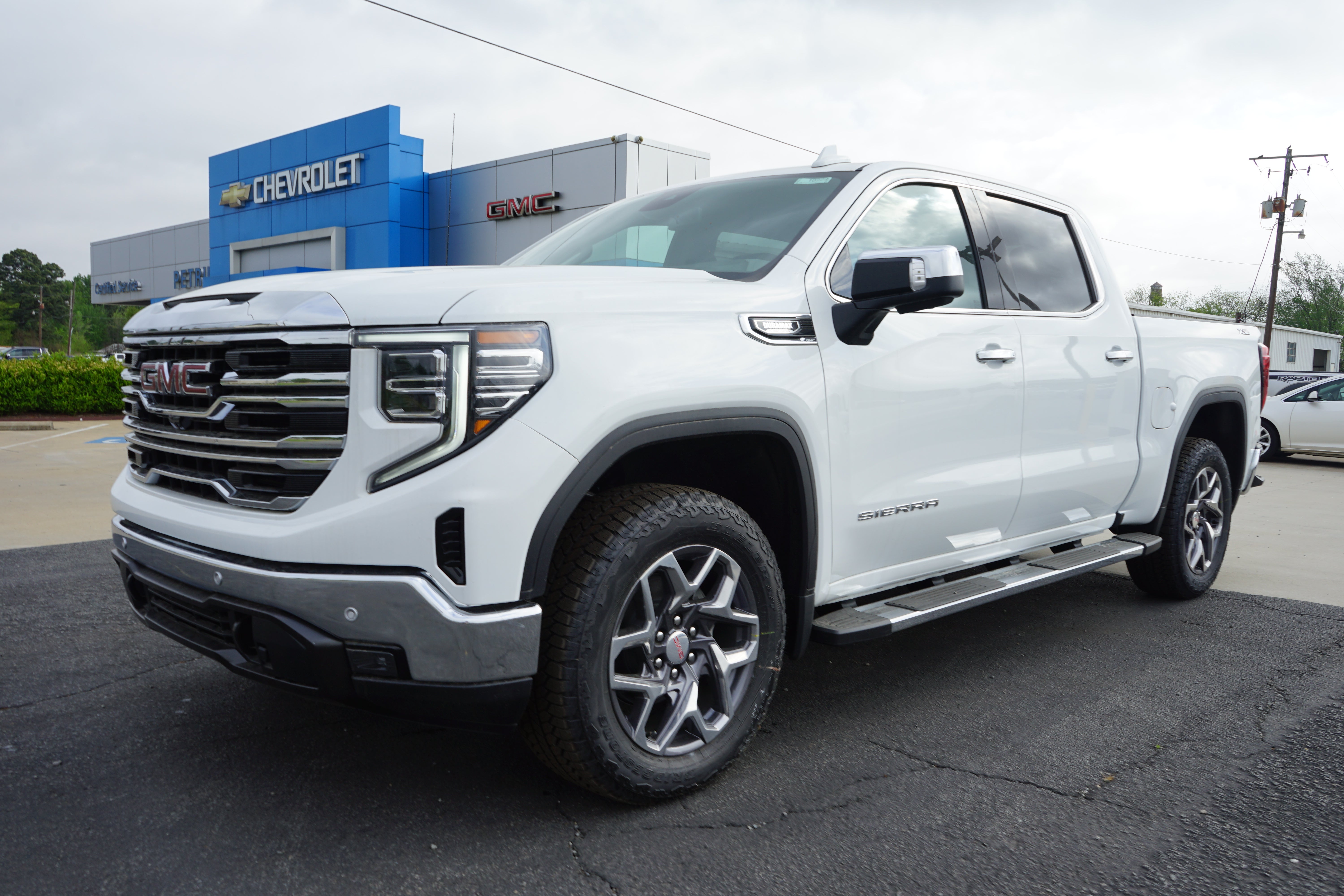 2026 GMC Sierra 1500 SLT in Summit White — front three-quarter view